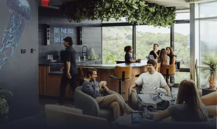 The Ways2Well lounge, with the brand’s logo wall and the clinic bar beyond it